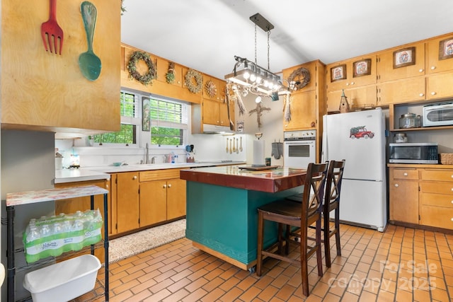 313 E Main St, Morganton, NC 28655 - kitchen featuring white appliances, brick patterned flooring, light countertops, and a center island