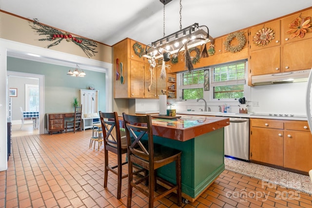 313 E Main St, Morganton, NC 28655 - kitchen featuring dishwasher, a chandelier, brick patterned floors, under cabinet range hood, and a kitchen bar