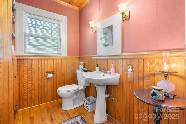 313 E Main St, Morganton, NC 28655 - half bathroom with crown molding, wainscoting, wood finished floors, and wooden walls