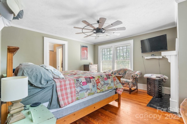 313 E Main St, Morganton, NC 28655 - bedroom featuring wood finished floors, crown molding, a textured ceiling, and ceiling fan