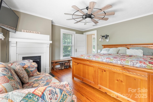 313 E Main St, Morganton, NC 28655 - bedroom featuring light wood-type flooring, a fireplace, ornamental molding, and a ceiling fan