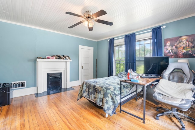313 E Main St, Morganton, NC 28655 - bedroom with ornamental molding, wood-type flooring, a fireplace with flush hearth, and a ceiling fan