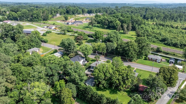 313 E Main St, Morganton, NC 28655 - aerial view of property and surrounding area featuring a heavily wooded area