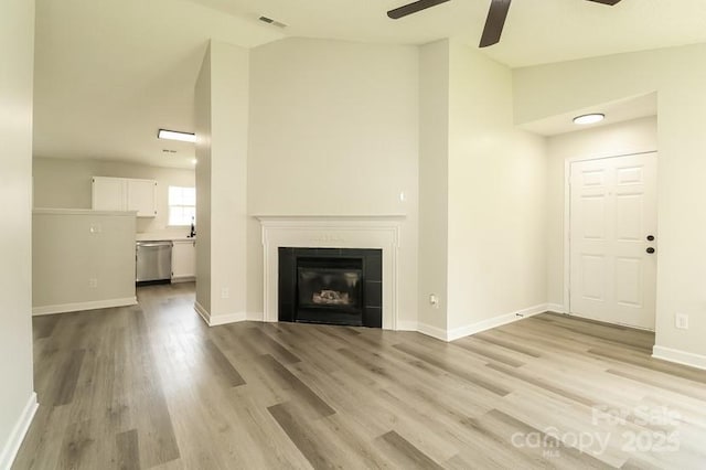 1628 Sandpiper Dr, Rock Hill, SC 29732 - unfurnished living room with a ceiling fan, high vaulted ceiling, light wood finished floors, and a glass covered fireplace