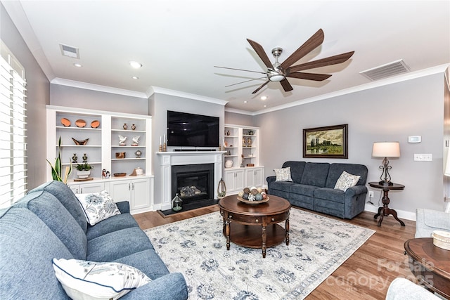 5129 Devonshire Rd, Denver, NC 28037 - living room with ceiling fan, wood finished floors, ornamental molding, a glass covered fireplace, and recessed lighting