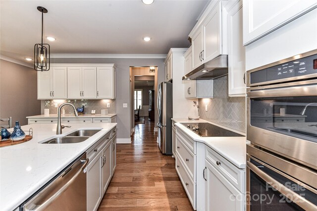 5129 Devonshire Rd, Denver, NC 28037 - kitchen featuring appliances with stainless steel finishes, under cabinet range hood, ornamental molding, white cabinets, and recessed lighting