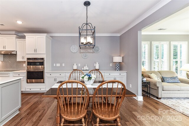 5129 Devonshire Rd, Denver, NC 28037 - dining area featuring dark wood-type flooring, crown molding, a chandelier, and recessed lighting
