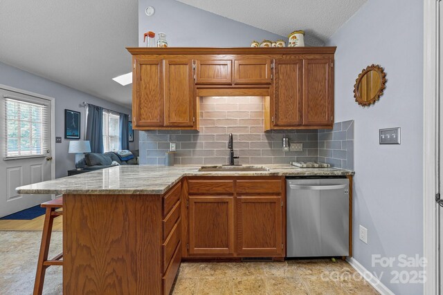 2906 Plantation Way, Albemarle, NC 28001 - kitchen with dishwasher, vaulted ceiling, decorative backsplash, brown cabinetry, and a breakfast bar