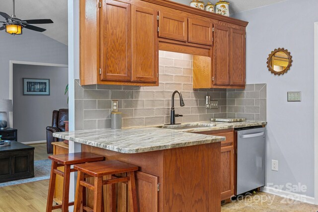 2906 Plantation Way, Albemarle, NC 28001 - kitchen featuring dishwasher, brown cabinetry, a ceiling fan, a peninsula, and tasteful backsplash