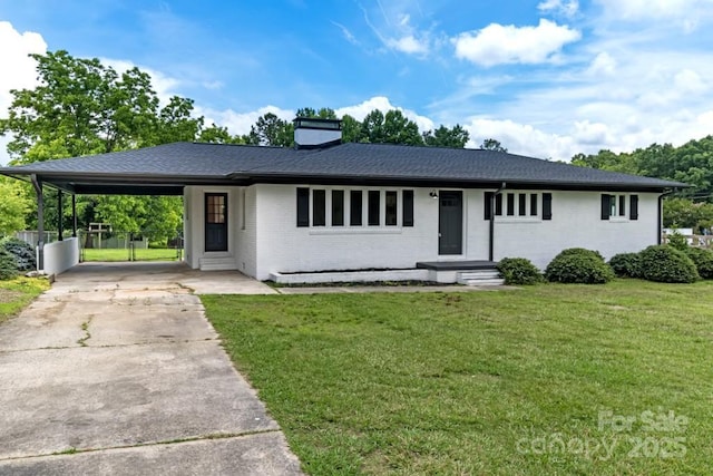 7724 E Holly Grove Rd, Thomasville, NC 27360 - single story home with driveway, a front lawn, a chimney, a carport, and brick siding