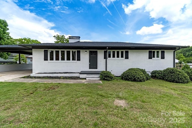 7724 E Holly Grove Rd, Thomasville, NC 27360 - ranch-style home with brick siding, a carport, a chimney, driveway, and a front lawn
