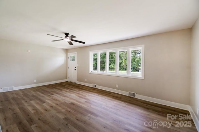 7724 E Holly Grove Rd, Thomasville, NC 27360 - empty room with a ceiling fan and wood finished floors