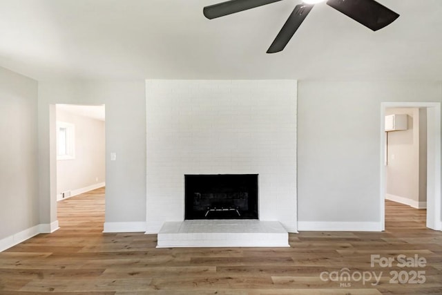 7724 E Holly Grove Rd, Thomasville, NC 27360 - detailed view of wood finished floors, a brick fireplace, and a ceiling fan