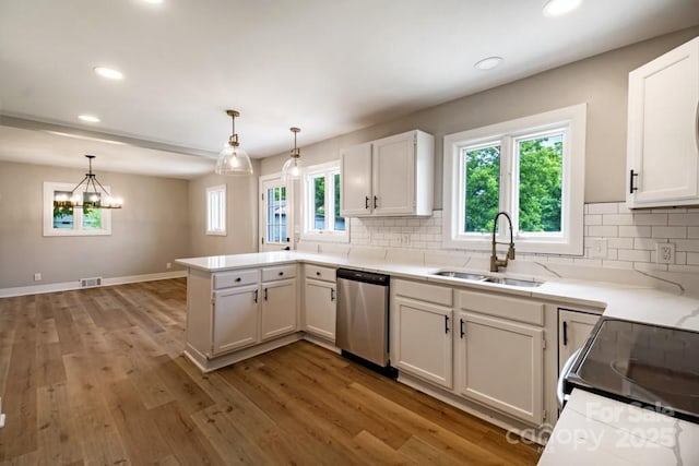 7724 E Holly Grove Rd, Thomasville, NC 27360 - kitchen with dishwasher, a peninsula, tasteful backsplash, light wood finished floors, and recessed lighting