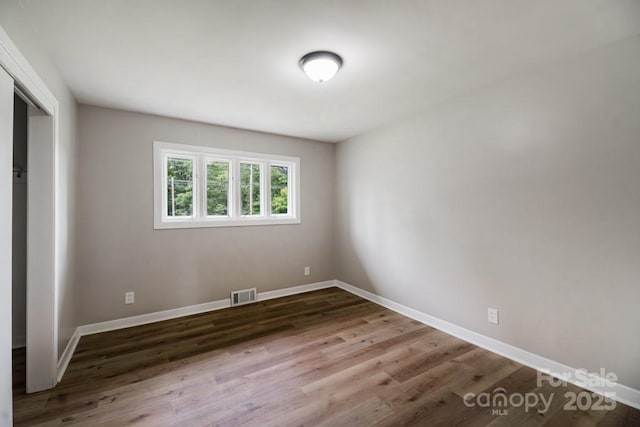 7724 E Holly Grove Rd, Thomasville, NC 27360 - unfurnished bedroom with wood finished floors and a closet