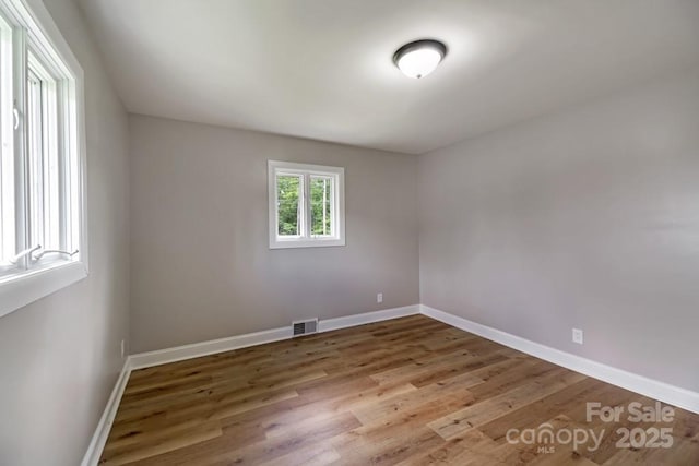 7724 E Holly Grove Rd, Thomasville, NC 27360 - spare room with wood finished floors