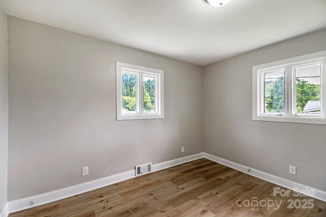 7724 E Holly Grove Rd, Thomasville, NC 27360 - spare room featuring baseboards and wood finished floors