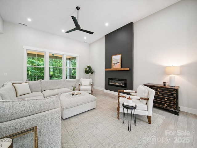 2108 Lakeview Cir, Matthews, NC 28105 - living area with light wood finished floors, a ceiling fan, a fireplace, and recessed lighting