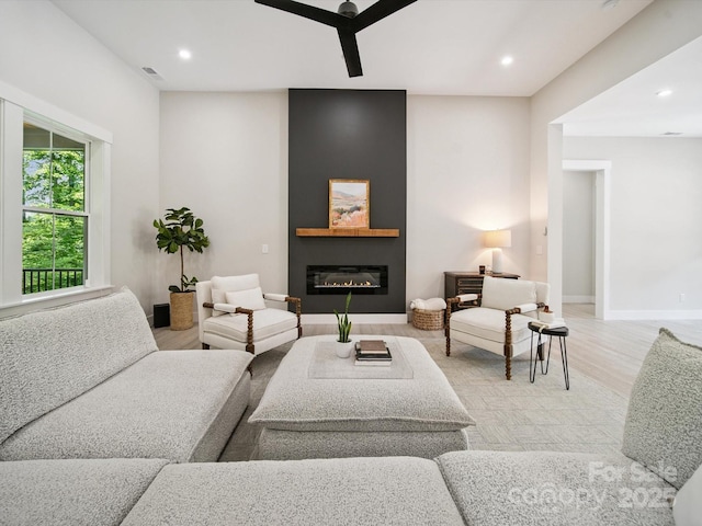 2108 Lakeview Cir, Matthews, NC 28105 - living room with light wood-style flooring, a glass covered fireplace, and recessed lighting