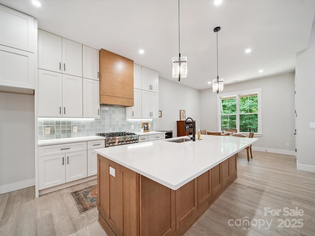 2108 Lakeview Cir, Matthews, NC 28105 - kitchen featuring light wood-style flooring, premium range hood, white cabinetry, and recessed lighting