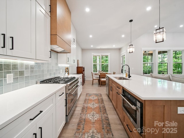 2108 Lakeview Cir, Matthews, NC 28105 - kitchen featuring stainless steel appliances, decorative backsplash, light countertops, recessed lighting, and light wood-style flooring