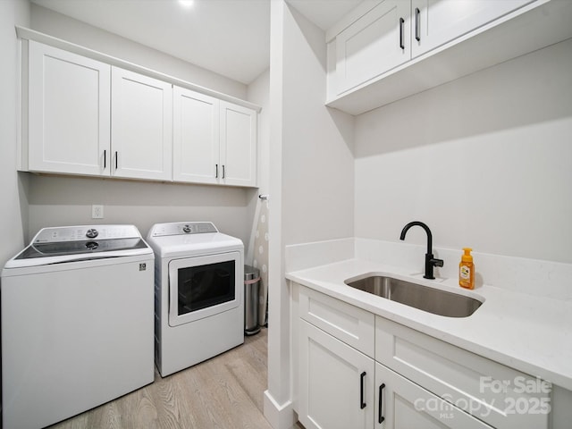 2108 Lakeview Cir, Matthews, NC 28105 - laundry room with washer and dryer, cabinet space, and light wood-style flooring