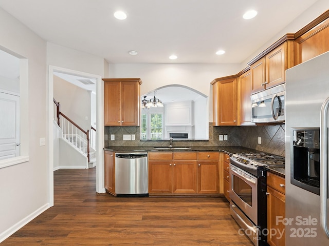 570 Sixth Baxter Xing Unit 16, Fort Mill, SC 29708 - kitchen with stainless steel appliances, dark wood-style flooring, tasteful backsplash, recessed lighting, and brown cabinets