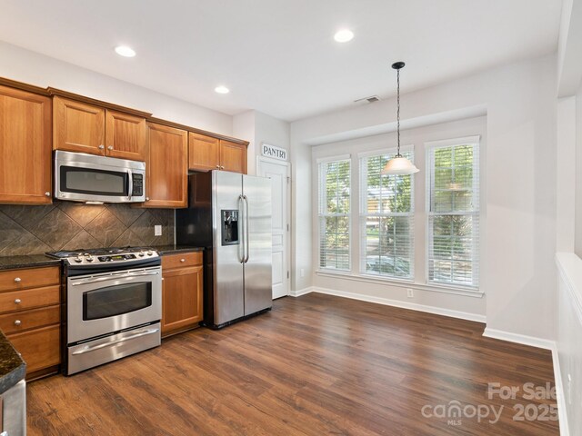 570 Sixth Baxter Xing Unit 16, Fort Mill, SC 29708 - kitchen featuring stainless steel appliances, brown cabinetry, dark wood-type flooring, backsplash, and recessed lighting