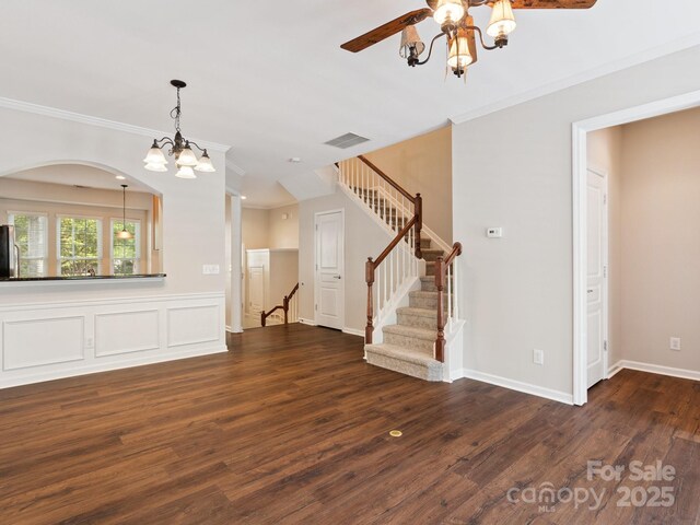 570 Sixth Baxter Xing Unit 16, Fort Mill, SC 29708 - unfurnished living room featuring a chandelier, stairway, dark wood-style floors, ornamental molding, and arched walkways