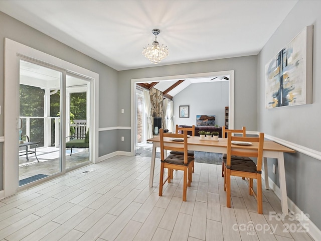 14019 Fountain Ln, Charlotte, NC 28278 - dining space with plenty of natural light, a chandelier, lofted ceiling, and light wood-style flooring