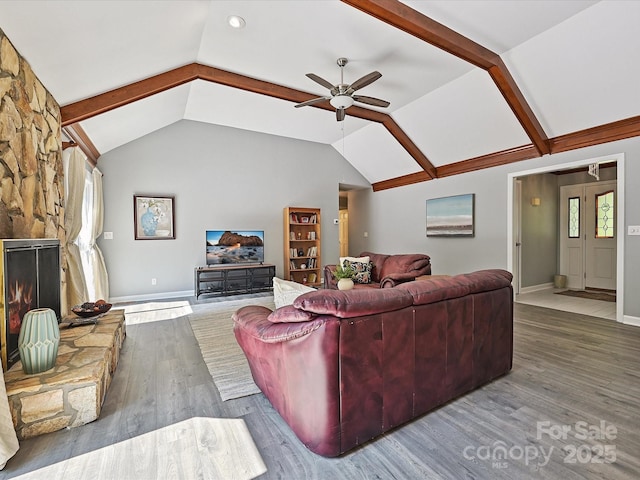 14019 Fountain Ln, Charlotte, NC 28278 - living room with lofted ceiling, wood finished floors, ceiling fan, and a stone fireplace