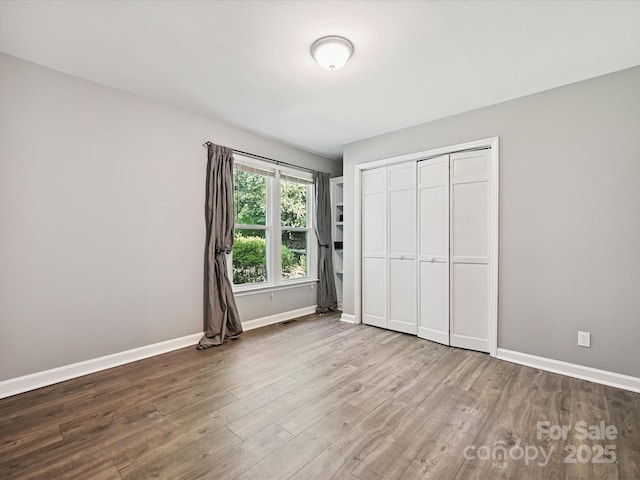 14019 Fountain Ln, Charlotte, NC 28278 - unfurnished bedroom with wood finished floors and a closet