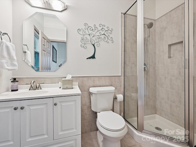 14019 Fountain Ln, Charlotte, NC 28278 - bathroom with vanity, a shower stall, tile walls, a wainscoted wall, and tile patterned flooring