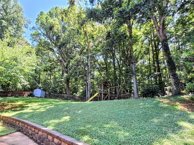 3616 Fair Oaks Pl NW, Concord, NC 28027 - view of yard with a storage unit and a playground