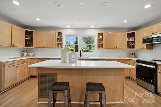 7109 Forney Hill Rd, Denver, NC 28037 - kitchen with open shelves, stainless steel appliances, light brown cabinets, a kitchen breakfast bar, and recessed lighting