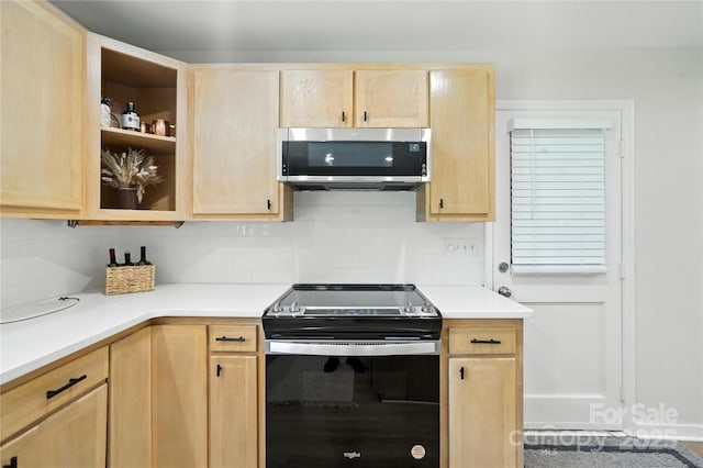 7109 Forney Hill Rd, Denver, NC 28037 - kitchen featuring stainless steel microwave, electric stove, light brown cabinetry, and backsplash