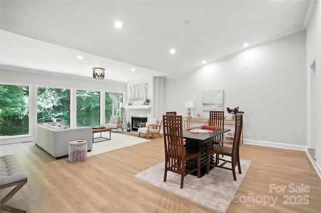 7109 Forney Hill Rd, Denver, NC 28037 - dining room with recessed lighting, crown molding, a fireplace, and light wood-style flooring