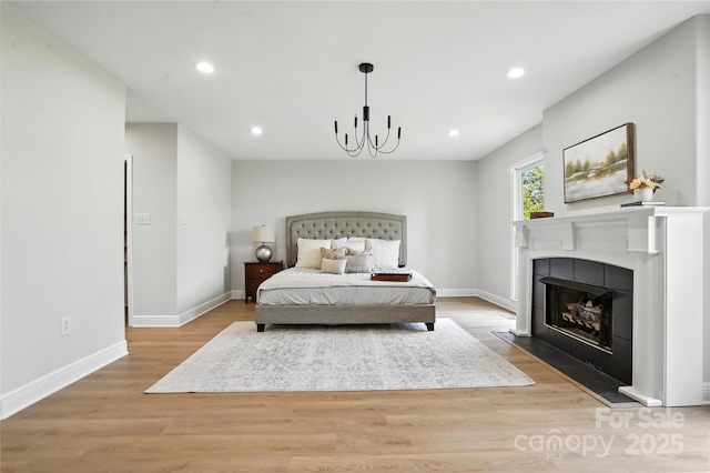 7109 Forney Hill Rd, Denver, NC 28037 - bedroom featuring wood finished floors, recessed lighting, a fireplace, and a chandelier