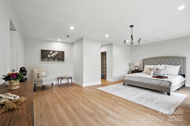 7109 Forney Hill Rd, Denver, NC 28037 - bedroom featuring light wood-type flooring, a chandelier, recessed lighting, and a walk in closet