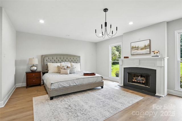 7109 Forney Hill Rd, Denver, NC 28037 - bedroom featuring light wood finished floors, a fireplace, recessed lighting, and a chandelier