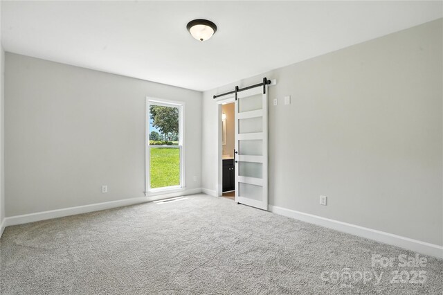 7109 Forney Hill Rd, Denver, NC 28037 - unfurnished bedroom with a barn door and carpet floors