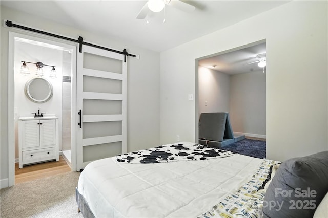7109 Forney Hill Rd, Denver, NC 28037 - bedroom featuring carpet flooring, a barn door, ceiling fan, and connected bathroom
