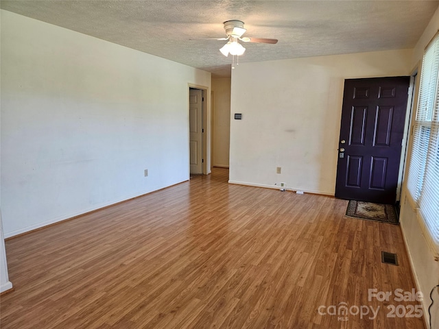 1982 Conley Rd, Morganton, NC 28655 - spare room featuring wood finished floors, ceiling fan, and a textured ceiling
