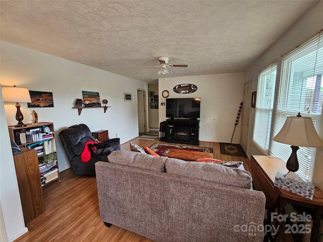 1982 Conley Rd, Morganton, NC 28655 - living room with light wood-type flooring, a ceiling fan, and a textured ceiling