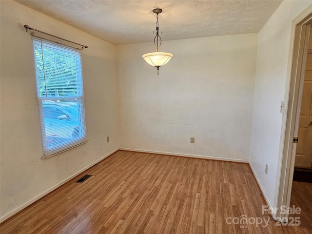 1982 Conley Rd, Morganton, NC 28655 - spare room with wood finished floors and a textured ceiling
