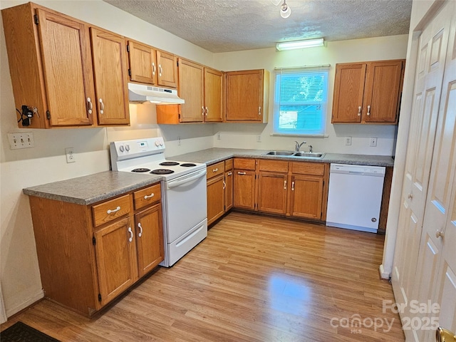 1982 Conley Rd, Morganton, NC 28655 - kitchen featuring white appliances, under cabinet range hood, a textured ceiling, light wood-style flooring, and brown cabinets