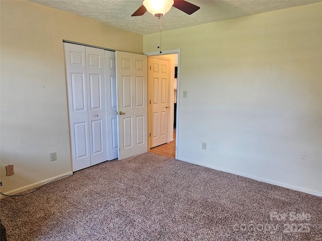 1982 Conley Rd, Morganton, NC 28655 - unfurnished bedroom featuring carpet flooring, a textured ceiling, a closet, and a ceiling fan
