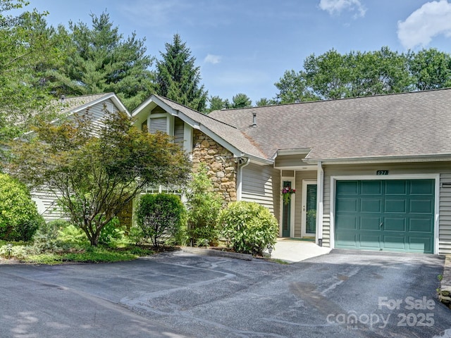 621 E Park Pl, Hendersonville, NC 28791 - view of front of home with asphalt driveway, stone siding, an attached garage, and roof with shingles
