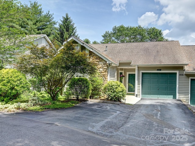 621 E Park Pl, Hendersonville, NC 28791 - view of front of house featuring asphalt driveway, stone siding, a garage, and roof with shingles