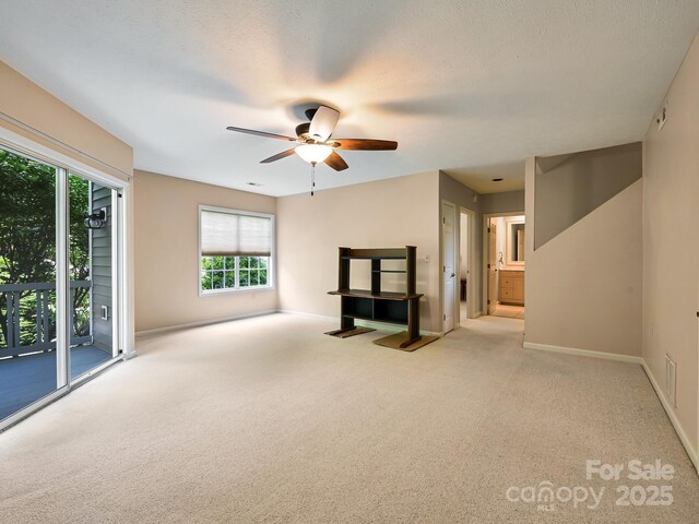 621 E Park Pl, Hendersonville, NC 28791 - unfurnished living room featuring carpet floors and a ceiling fan